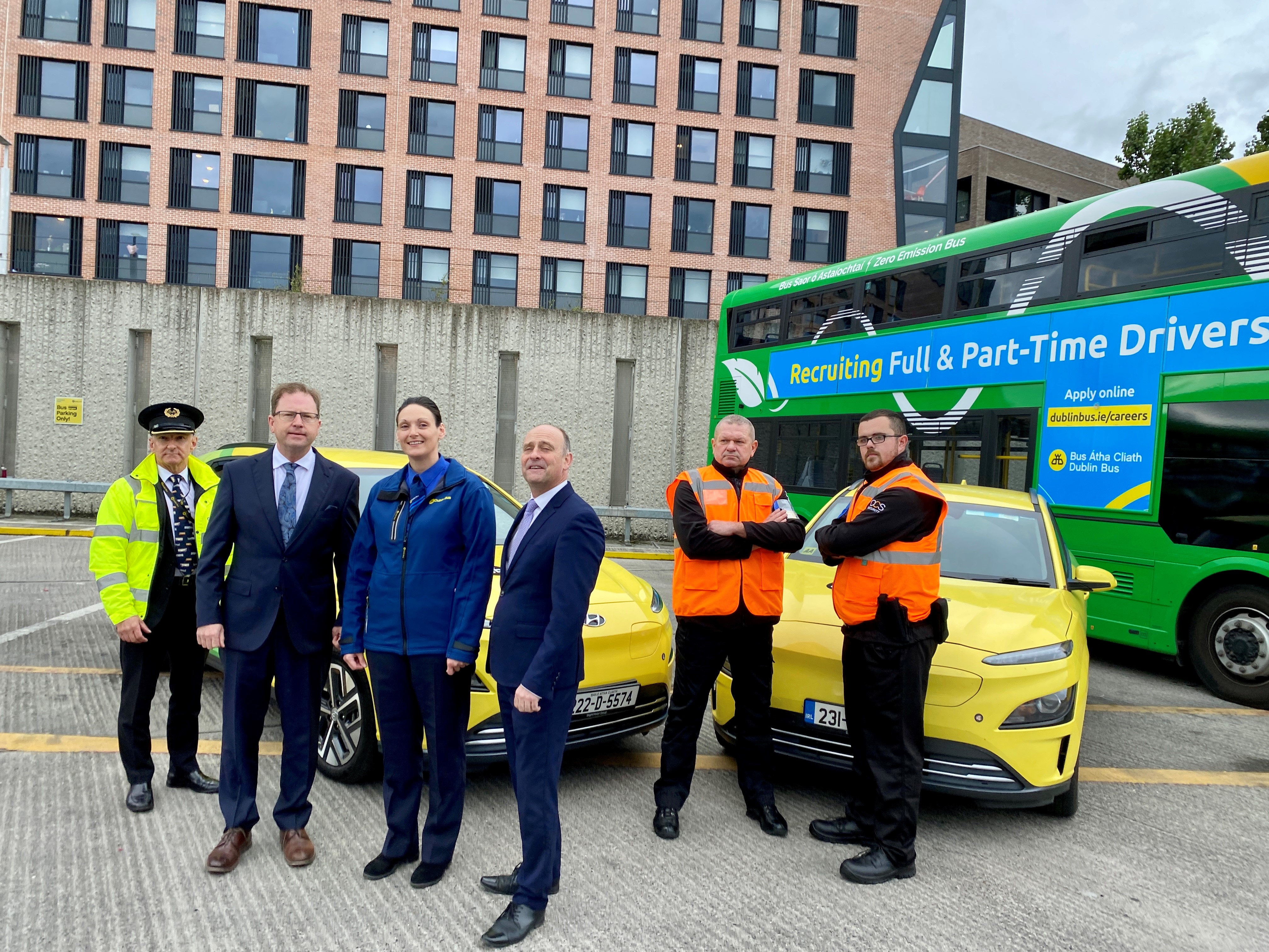 Image of Billy Hann (CEO), a female bus driver, our Safer Journey Team and Chief Inspector, all standing in front of a Dublin Bus and two green and yellow Dublin Bus cars in Broadstone bus depot Image of Billy Hann (CEO), a female bus driver, our Safer Journey Team and Chief Inspector, all standing in front of a Dublin Bus and two green and yellow Dublin Bus cars in Broadstone bus depot