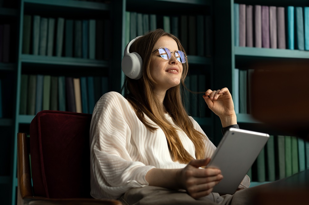 Young Woman Listening To Audiobook
