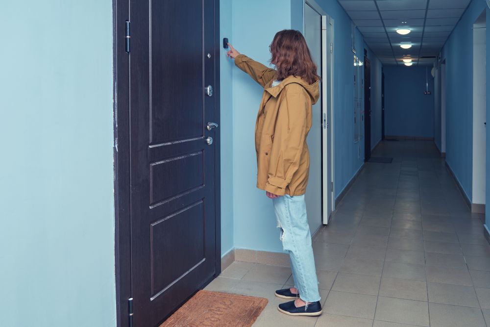 Woman ringing doorbell