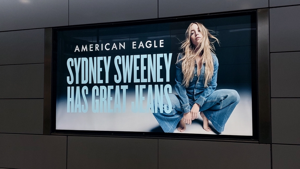 Sydney Sweeney Loses 200,000 Followers Amid Nude Ad Backlash 4 American Eagle advertising billboard with Sydney Sweeney and her great jeans.Jeans or genes. It has been controversial in the US 2025. Photo Credit:Zoltan Tarlacz / Shutterstock.com